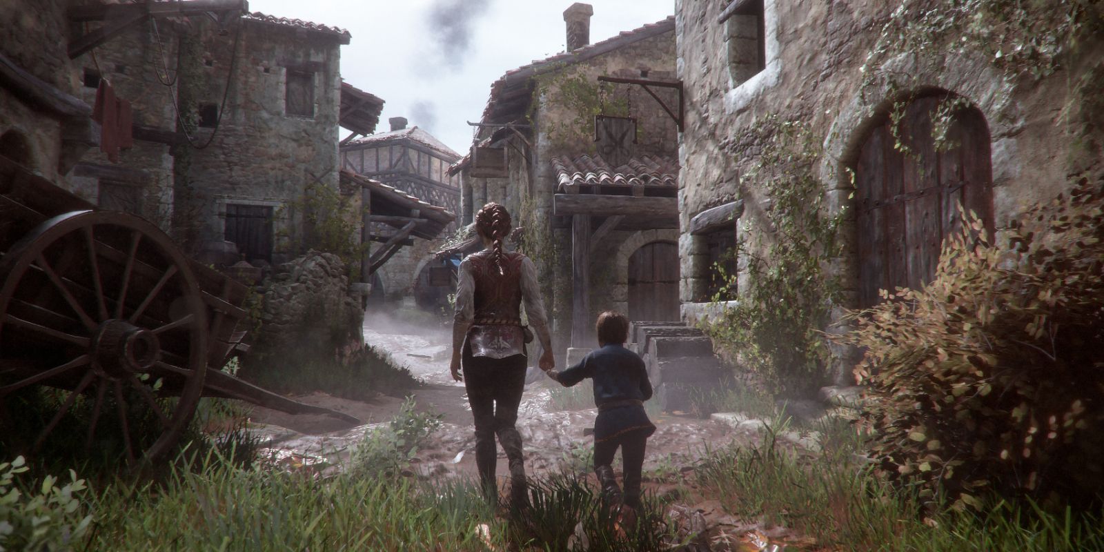 Amicia and Hugo walk through a deserted town in A Plague Tale: Innocence 