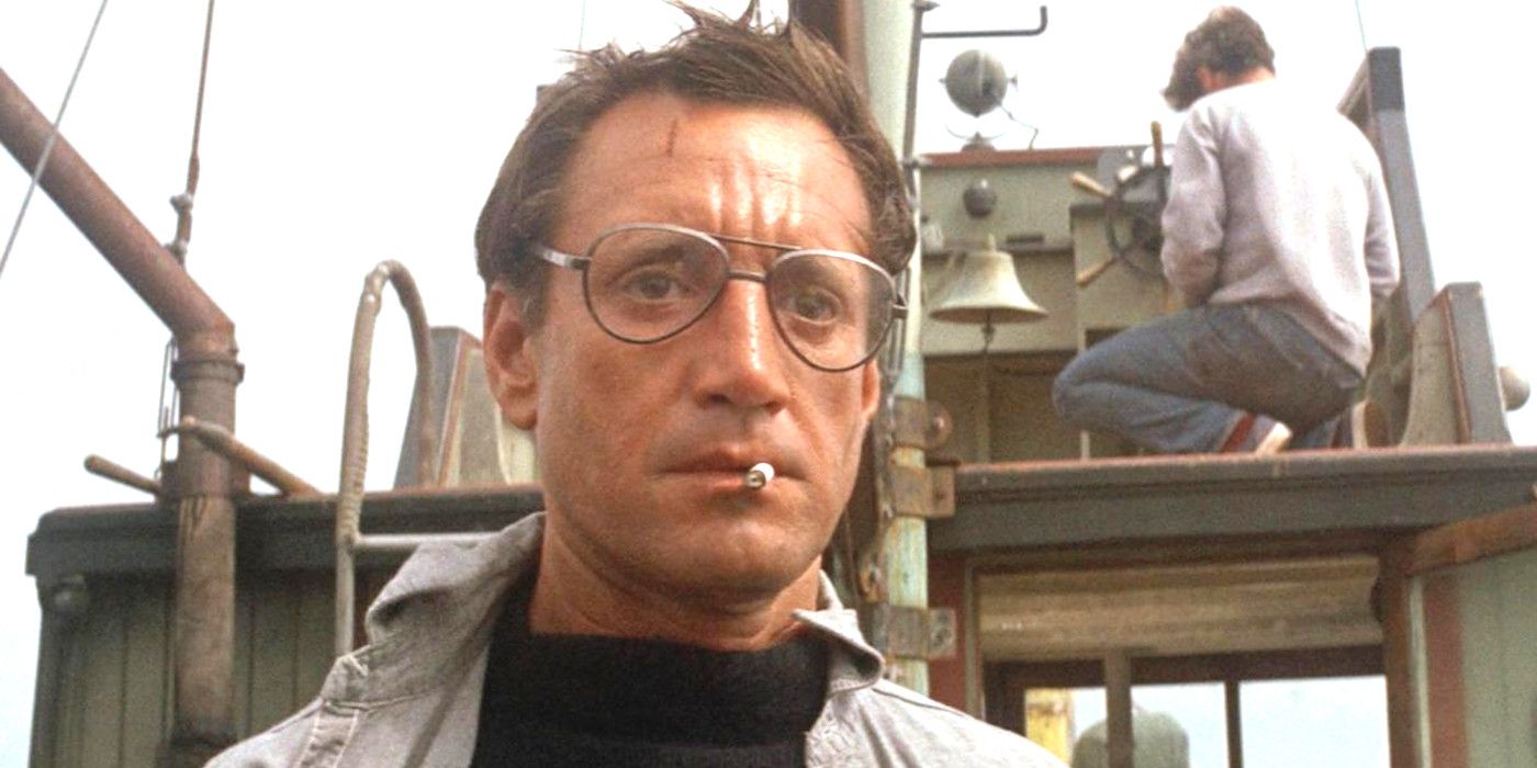 Roy Scheider In Jaws looking shocked on a boat with eyeglasses on and a cigarette dangling from his lips