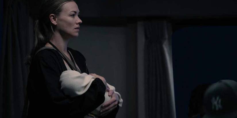 Serena Joy Waterford holding a baby and looking scared in The Handmaid's Tale Season 5.