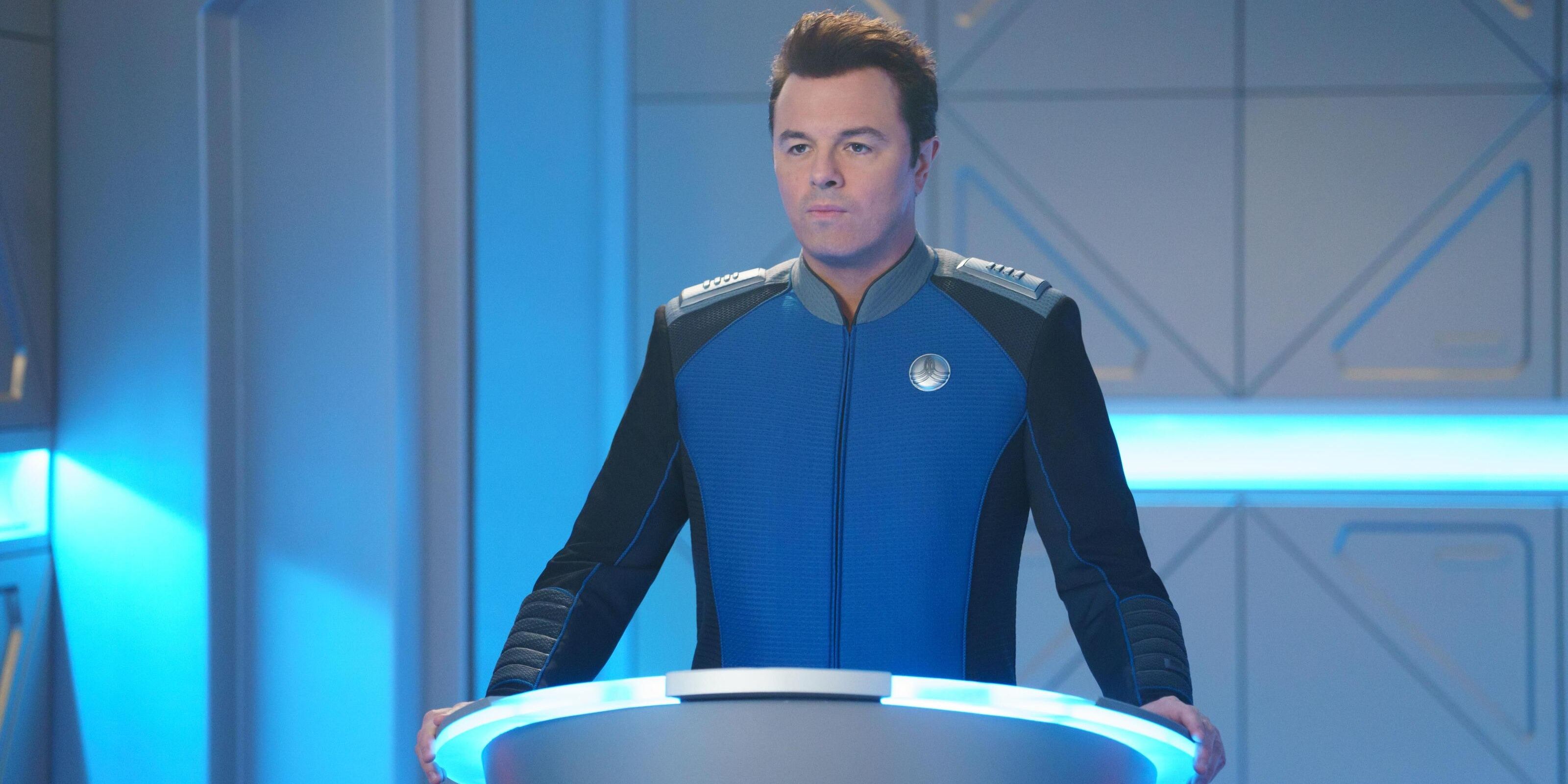 Seth MacFarlane standing on a podium in The Orville 