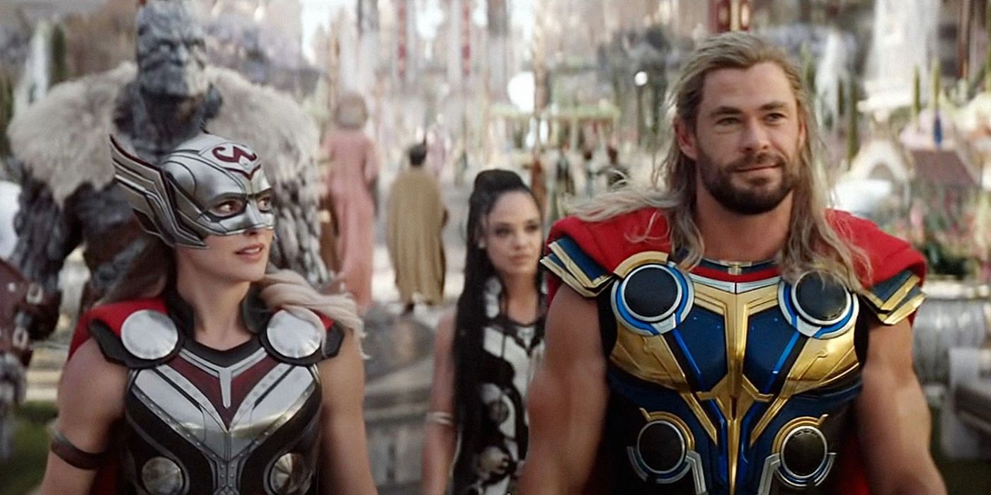 Natalie Portman as Jane Foster Mighty Thor and Chris Hemsworth as Thor walking together in front of Tessa Thompson as Valkyrie and Taika Waititi as Korg in Thor Love and Thunder