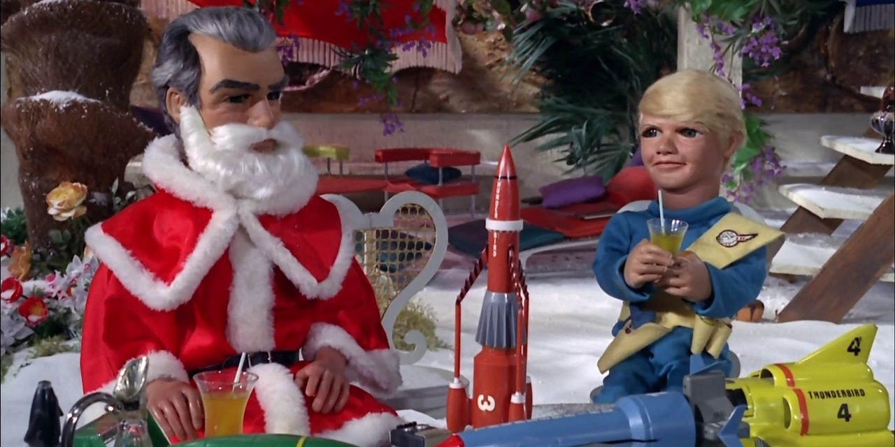 Jeff Tracy se veste de Papai Noel e entretém o convidado infantil Nicky em Tracy Island.