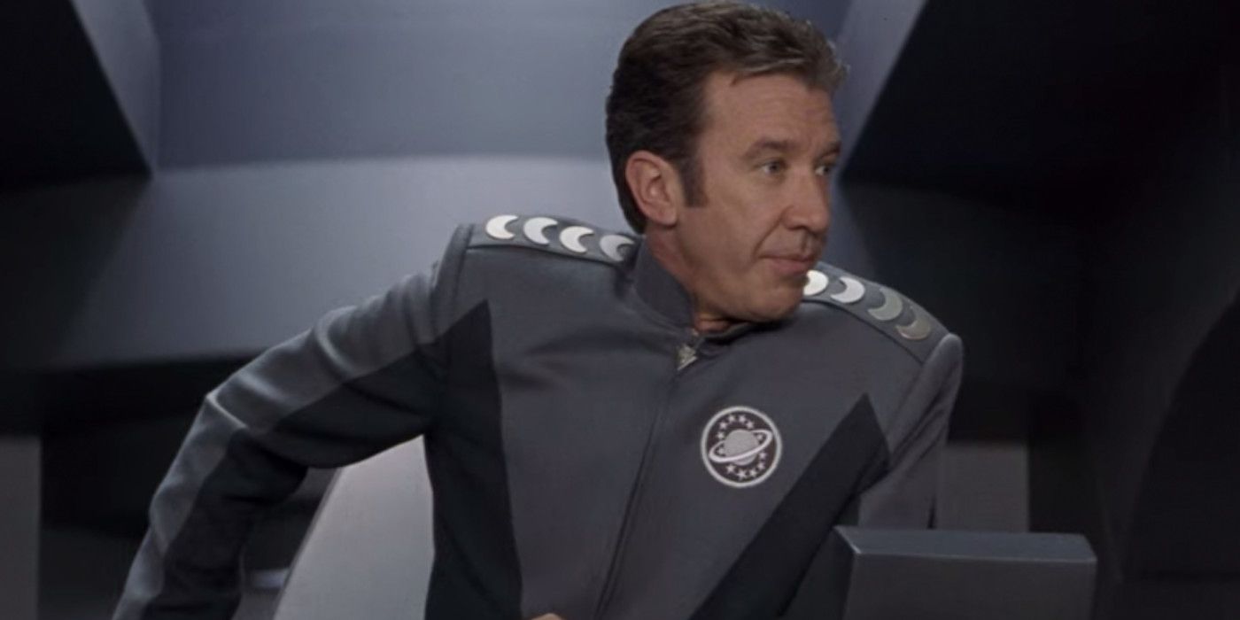 Tim Allen sitting in the captain's chair and leaning to the side in Galaxy Quest