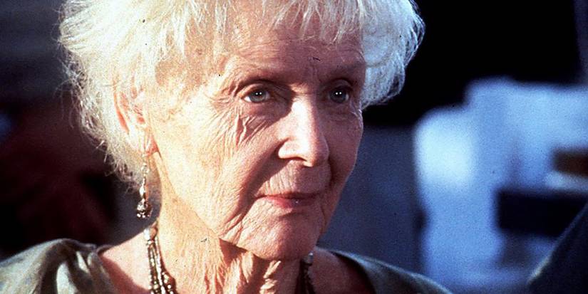 Gloria Stuart as Old Rose smiling slightly in Titanic.
