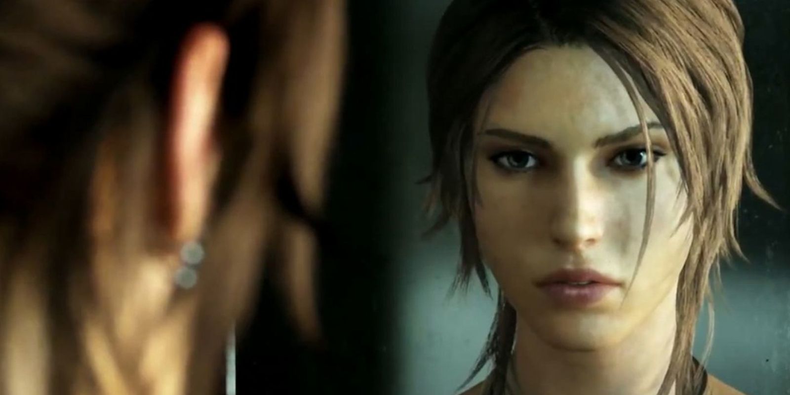 Lara Croft looks in the mirror in Tomb Raider (2013)