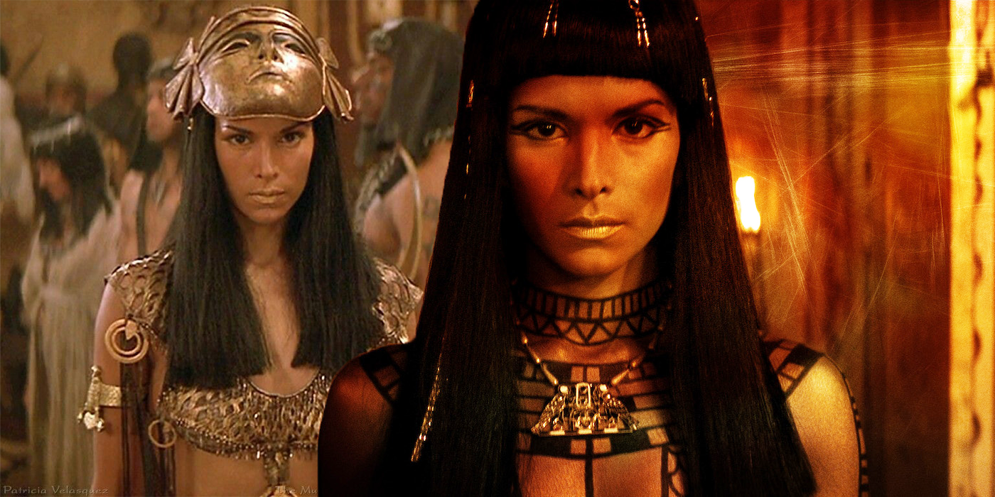 A woman with straight black hair and bangs in Egyptian costume