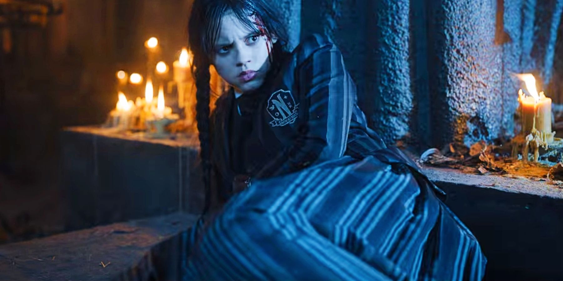 Jenna Ortega as Wednesday Addams, bleeding and on the ground in the crypt in the Wednesday season 1 ending