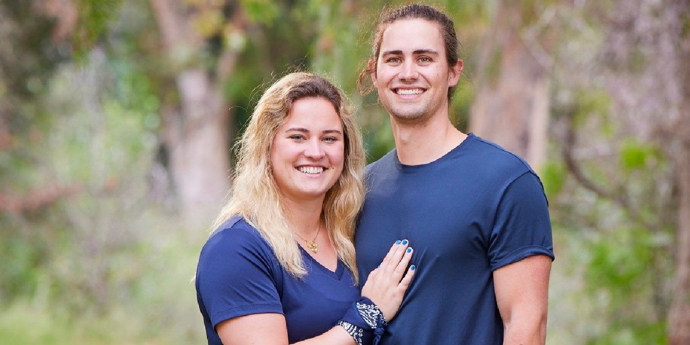 Will and Abby from The Amazing Race season 34 smiling with their blue team gear on.