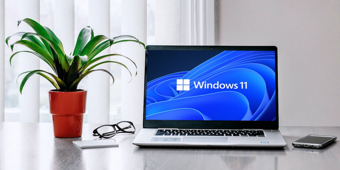 An open laptop with a Windows 11 logo showing on the screen