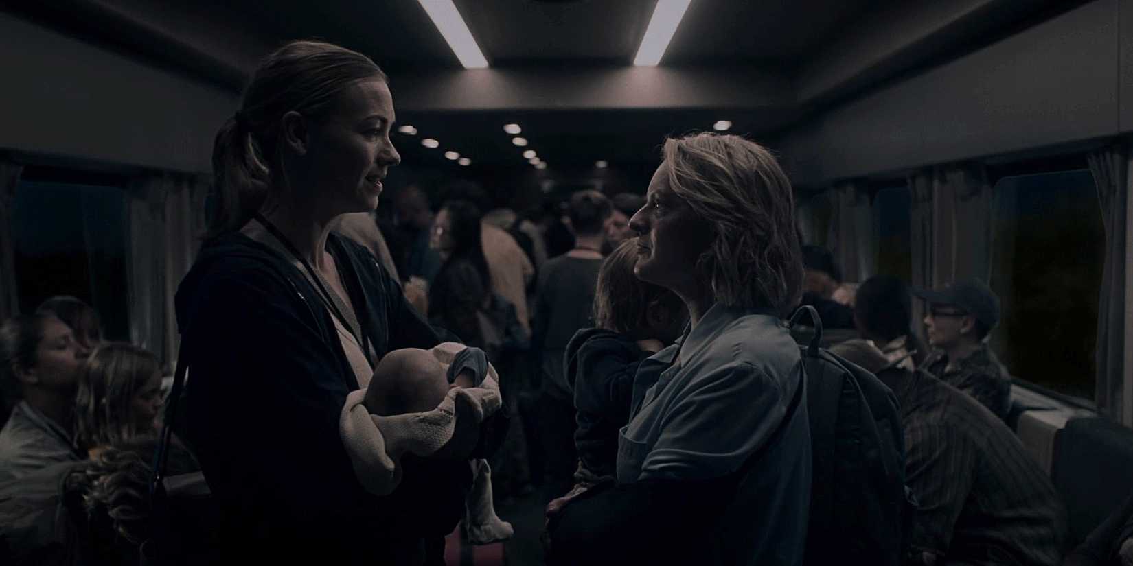 Serena (Yvonne Strahovski) with a baby talking to June (Elisabeth Moss) on the train in The Handmaid's Tale.