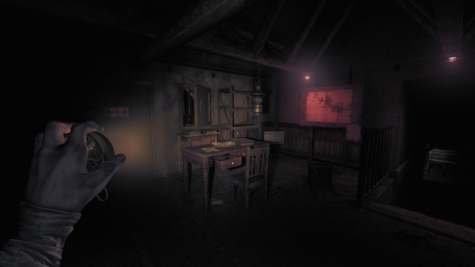 Amnesia The Bunker gameplay screenshot showing the player shining a light on what looks to be a desk and a map on the wall.