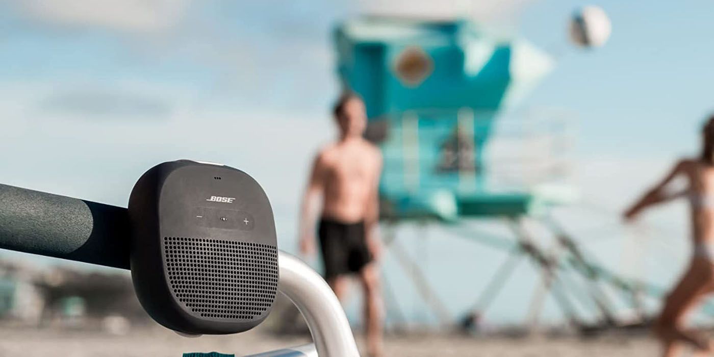bose soundlink mounted to a pole with a beach scene in the background