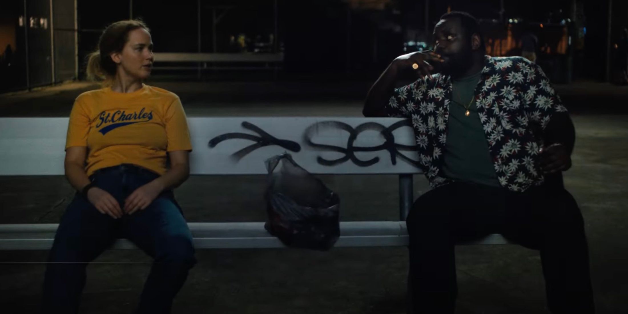 Jennifer Lawrence and Brian Tyree Henry on a bench in Causeway