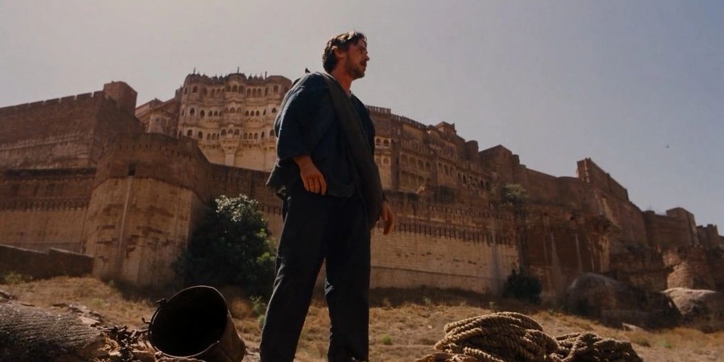 Bruce Wayne standing in the desert in The Dark Knight Rises 