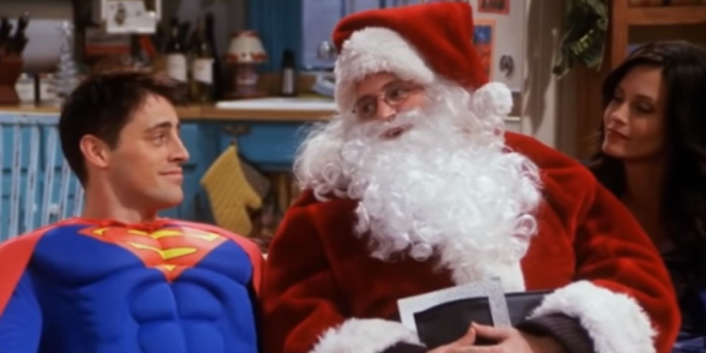 Chandler And Joey Dressed As Superman And Santa For Ben And Sitting On The Couch With Monica