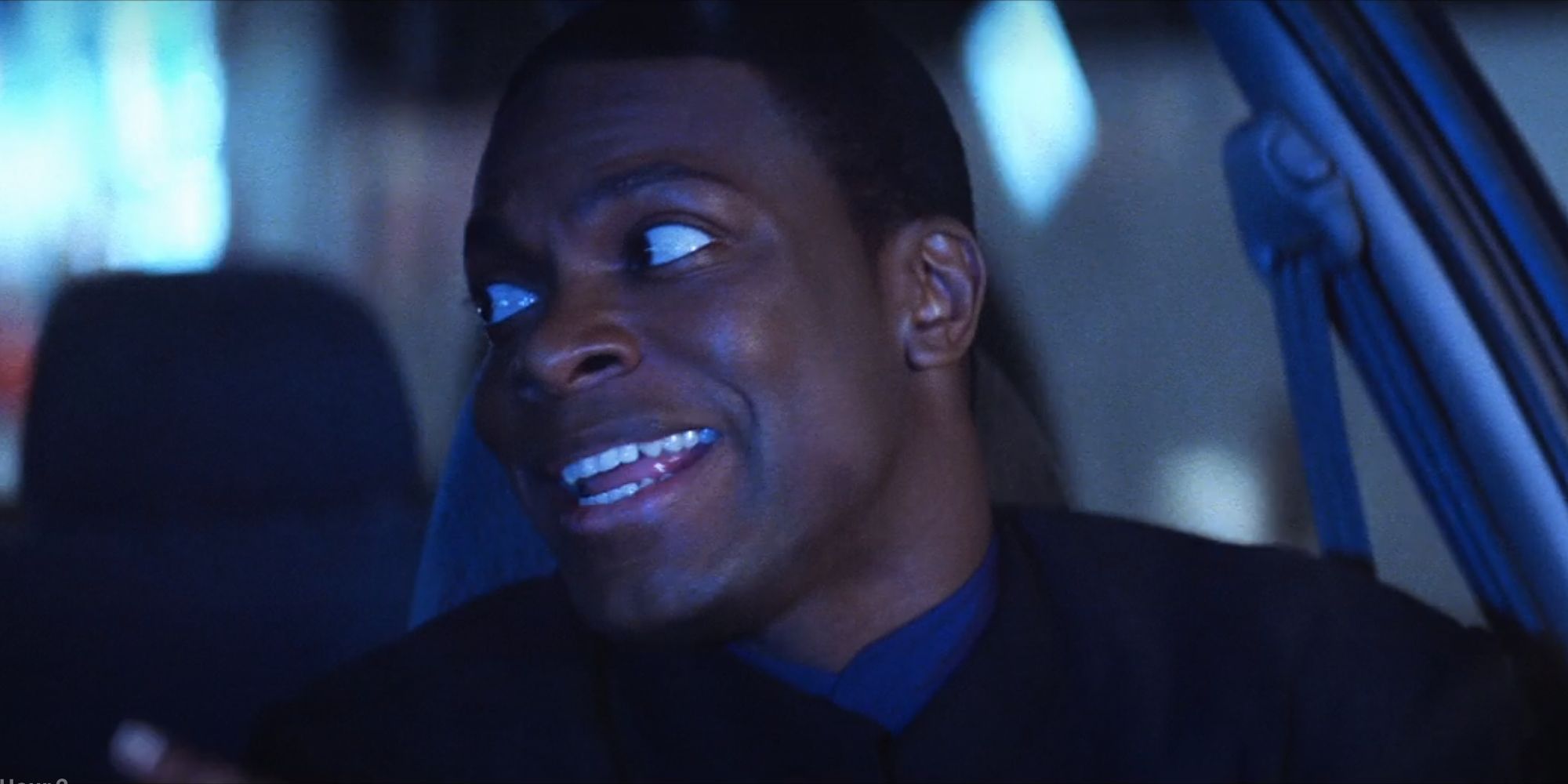 Chris Tucker as James Carter laughing in Lee's car in Rush Hour 2