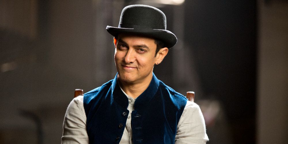 Khan sits on a chair in Dhoom 3