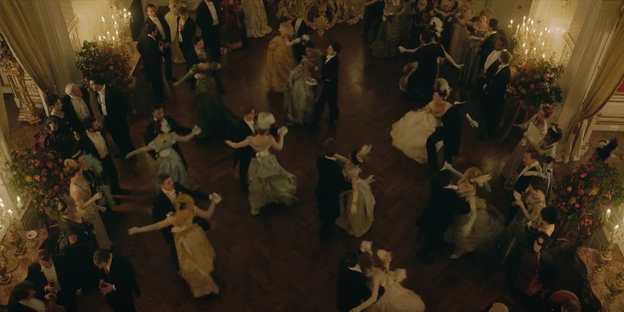 A bird's eye view shot of people dancing at a ball in Enola Holmes 
