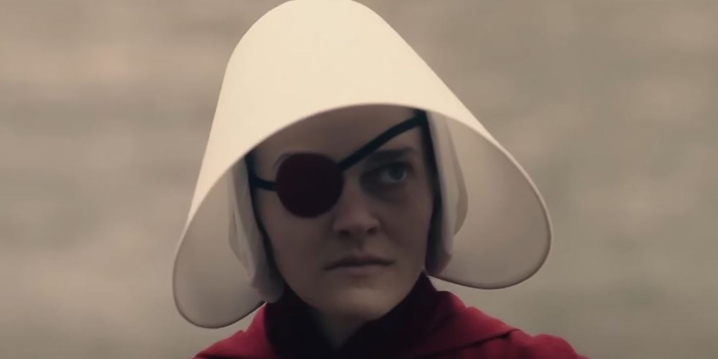 Janine in her handmaid outfit, looking upset on The Handmaid's Tale