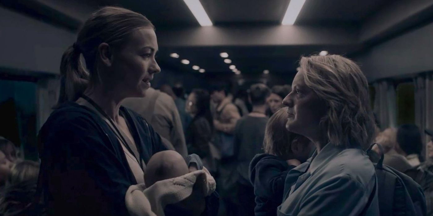 Serena and June standing face to face on a train on The Handmaid's Tale