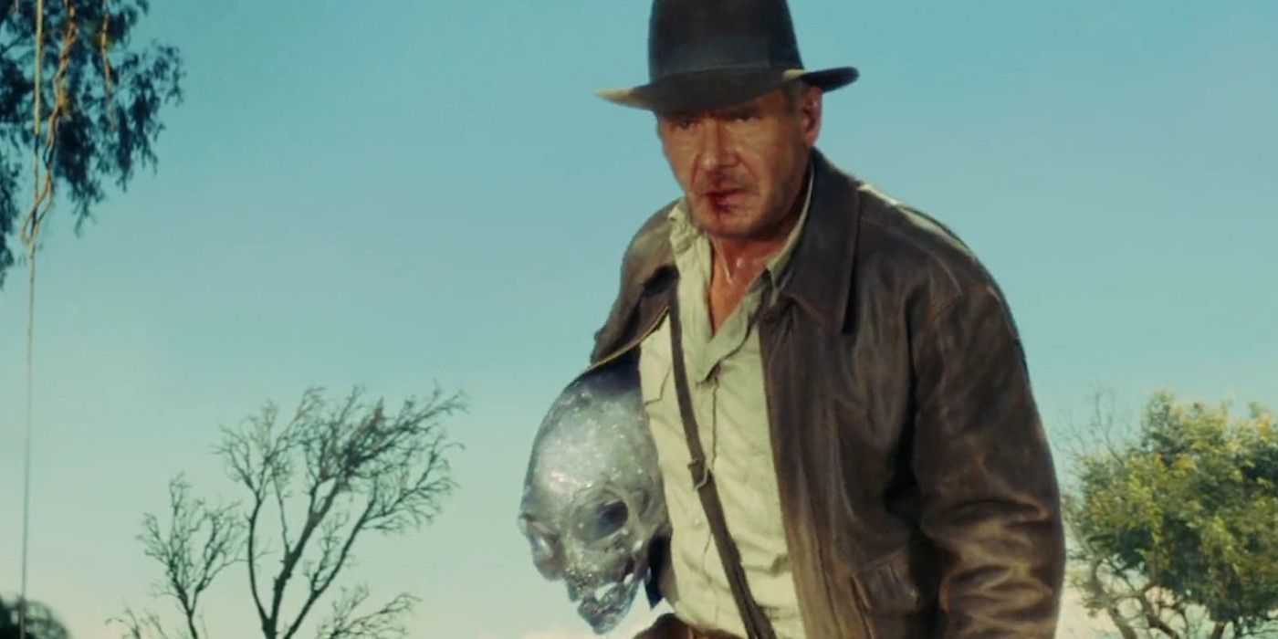 Harrison Ford as Indiana Jones in Indiana Jones 4 all bedraggled with a bloody lip, clutching grimly to an alien crystal skull as he tromps through the jungle