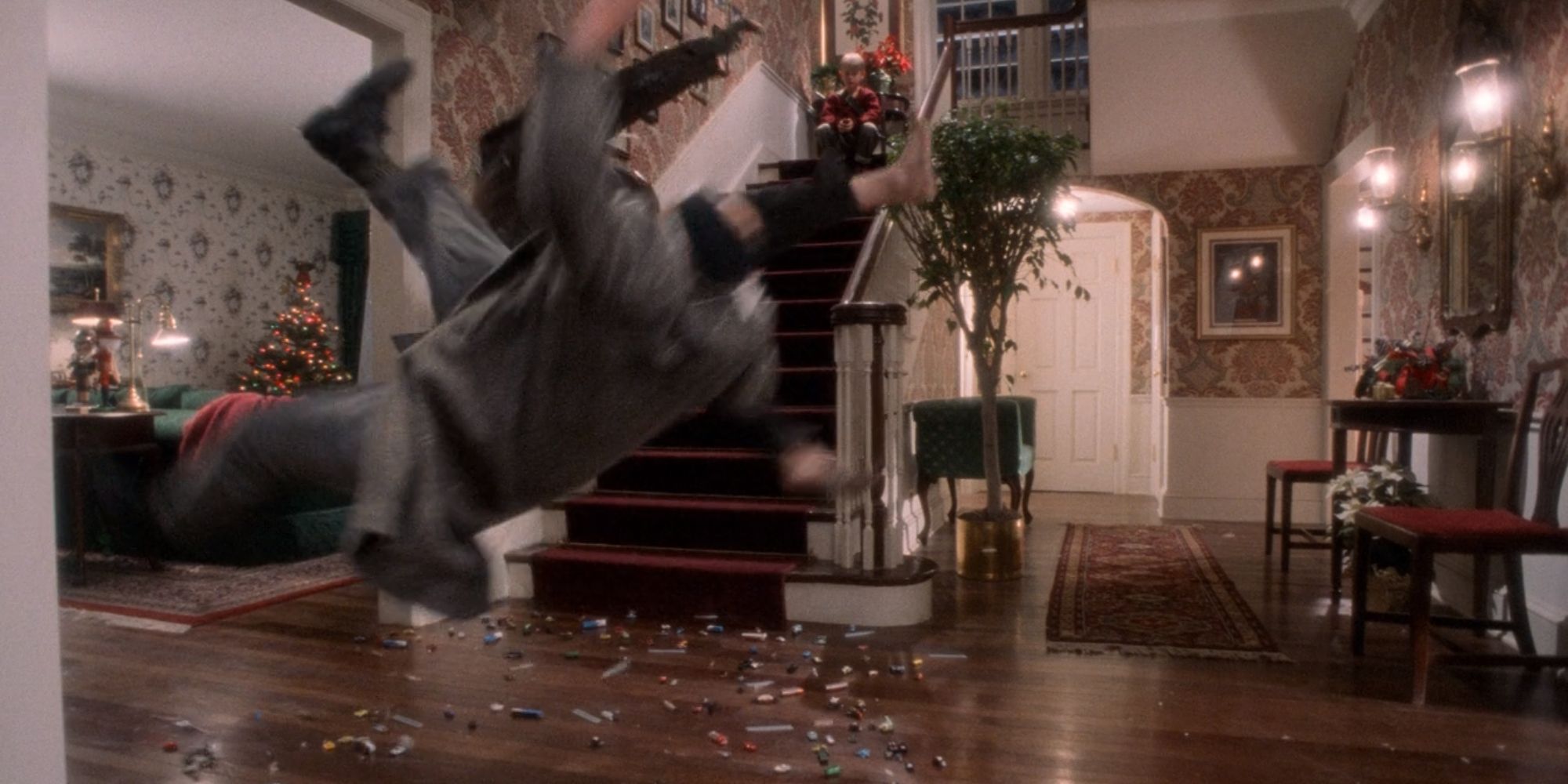 Harry and Marv being comedically flung into the air by toy cars in Home Alone (1990)