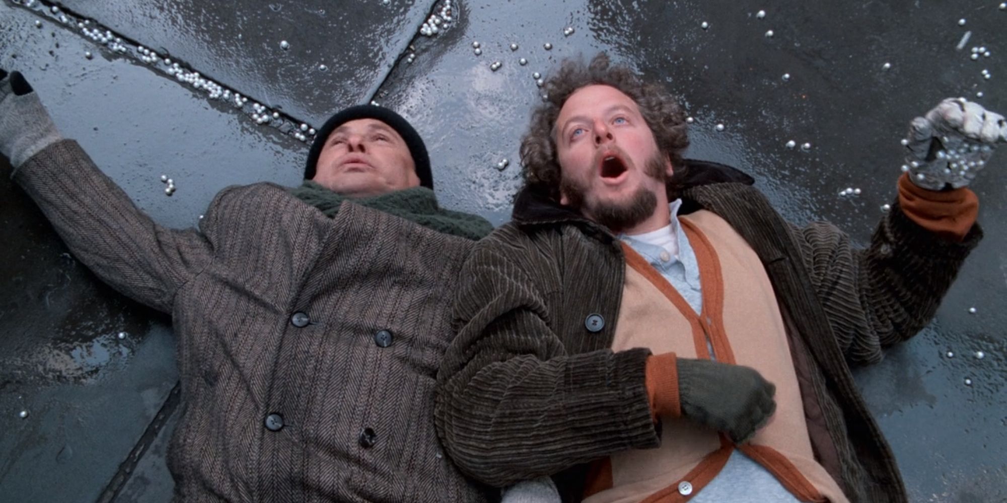Harry and Marv lying on the sidewalk with marbles in Home Alone 2 Lost In New York (1991)