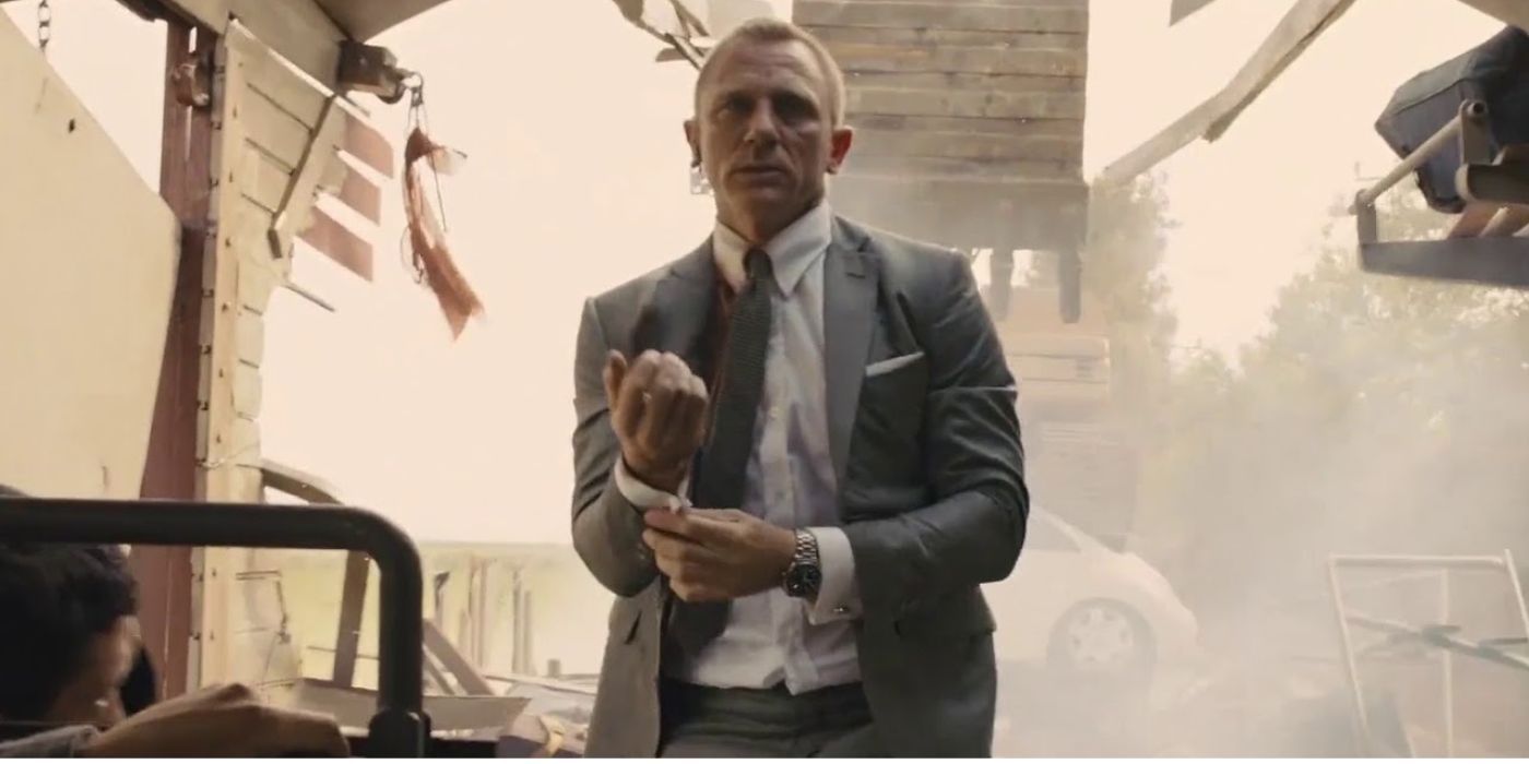 James Bond (Daniel Craig) fixing his cufflink in a destroyed train car in Skyfall.