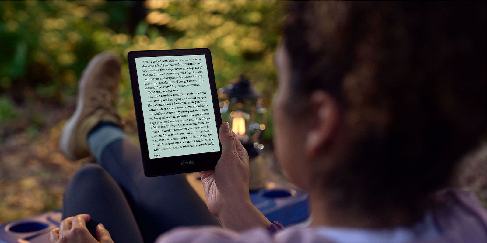 A woman reading the Kindle Paperwhite Signature Edition
