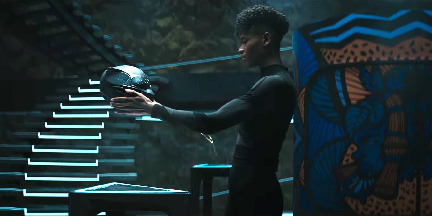 Letitia Wright as Shuri holding the Black Panther helmet in Black Panther: Wakanda Forever.