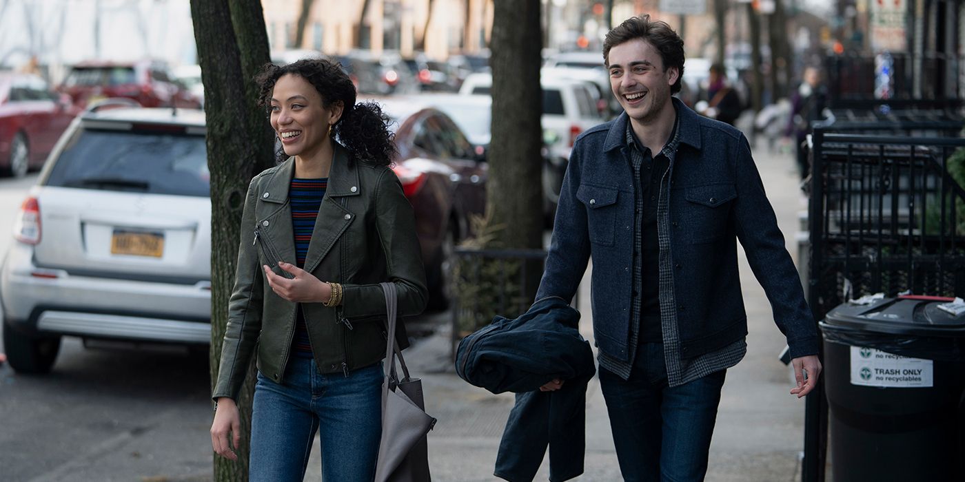 Violet and Cal from Manifest, walking down the street smiling and laughing