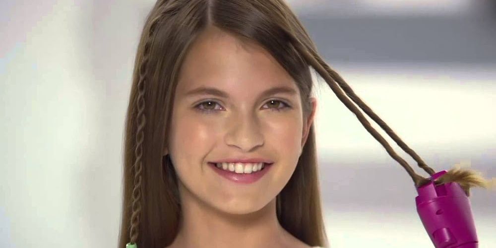 Child smiles while using the Conair quick twist