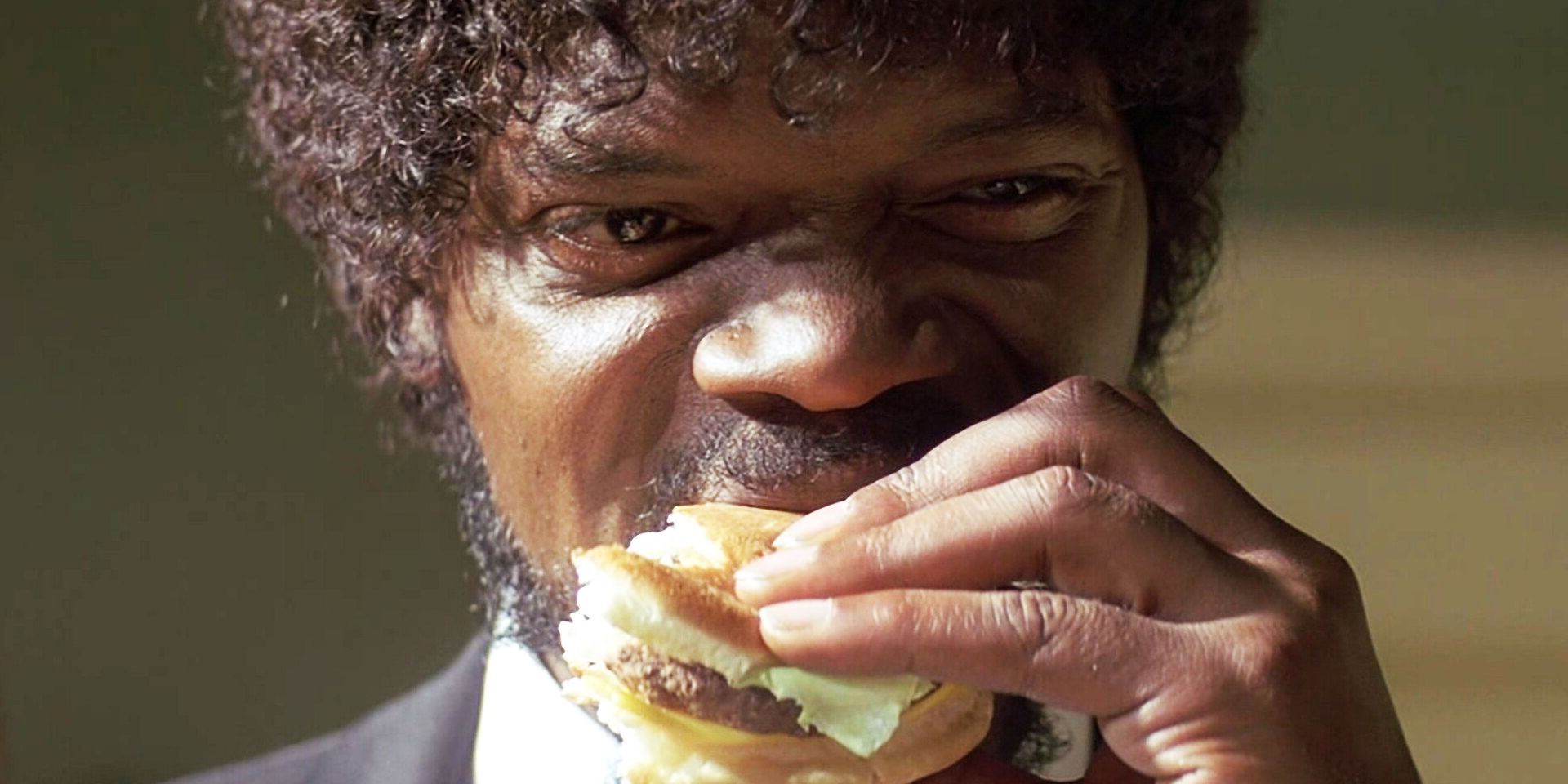 Jules Winnfield eats a cheeseburger in Pulp Fiction