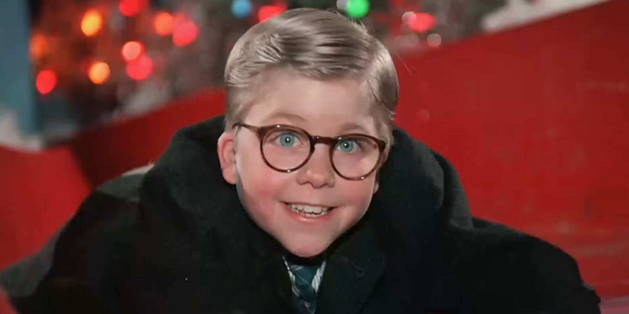 Ralphie Parker grinning on the slide in A Christmas Story