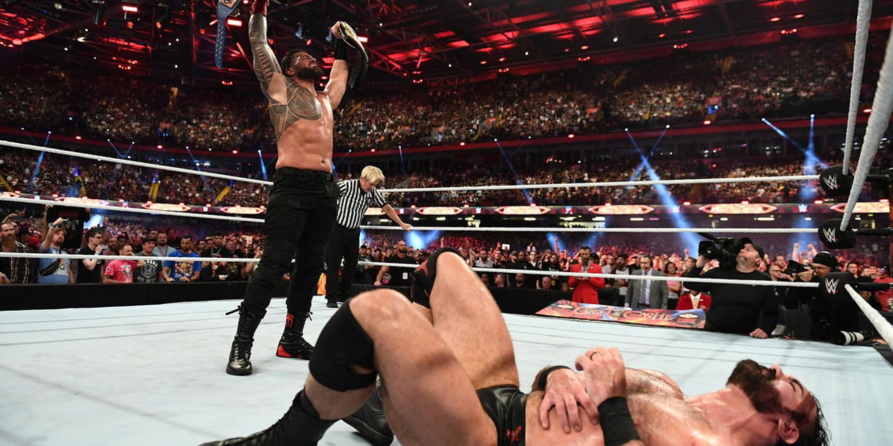 Roman Reigns celebrates his victory over Drew McIntyre at WWE Clash At The Castle.
