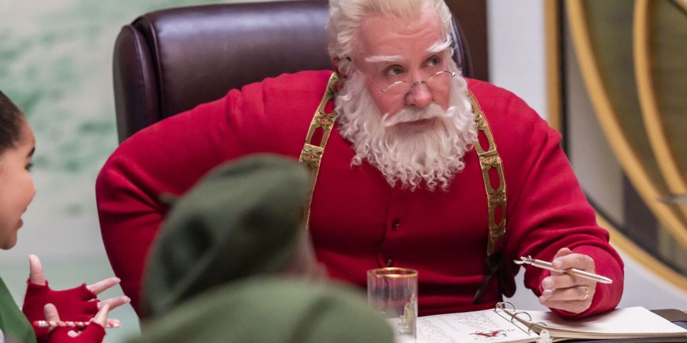 Scott/Papai Noel sentado em uma mesa em The Santa Clauses