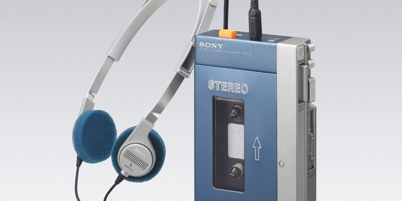 Blue and silver Sony Walkman with headphones connected