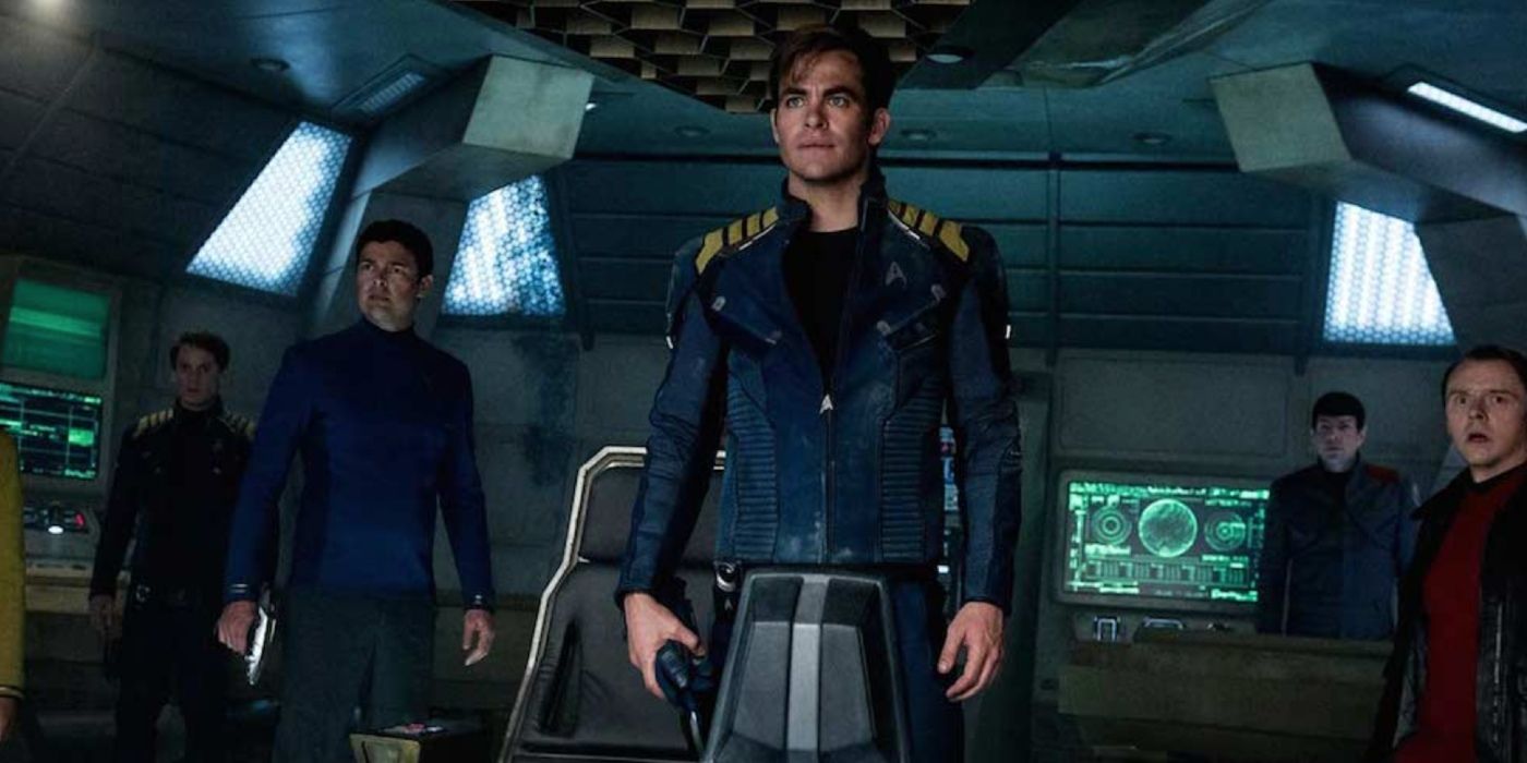 Chris Pine stands on the bridge of the Enterprise with his crew in Star Trek Beyond.