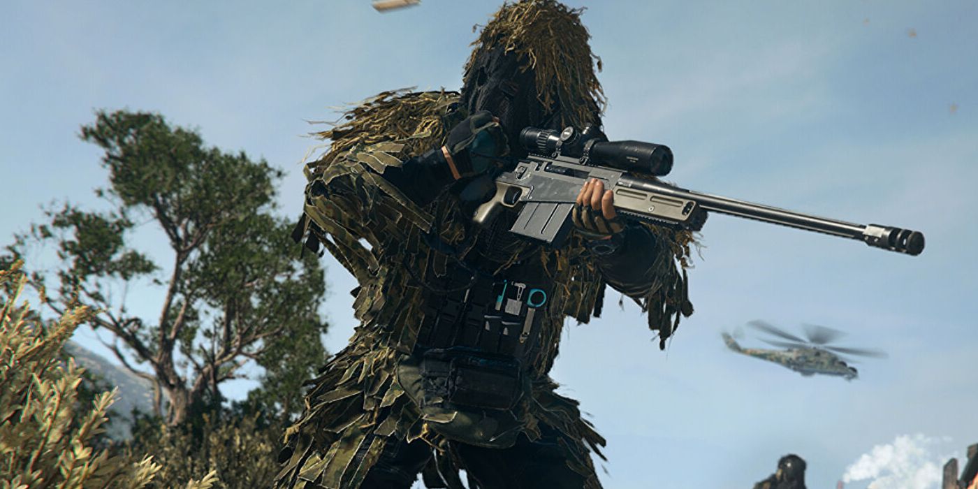 A Warzone 2 player wearing a ghillie suit and pulling the bolt on a sniper rifle.
