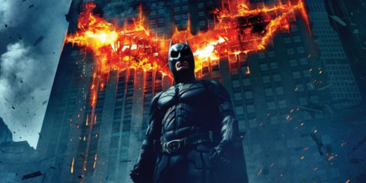 The Dark Knight promo poster featuring Batman standing in front of a burning bat symbol.