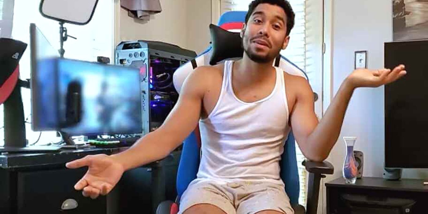 Pedro Jimeno of the Chantel family sitting in front of his computer in a white tank top and shorts