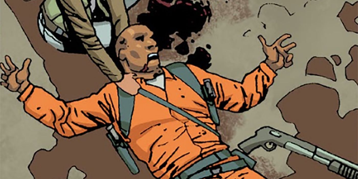 Dexter from The Walking Dead comics, lying on the ground in an orange prison jumpsuit being attacked by walkers.