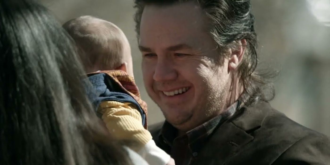 Eugene holding his baby and smiling on The Walking Dead