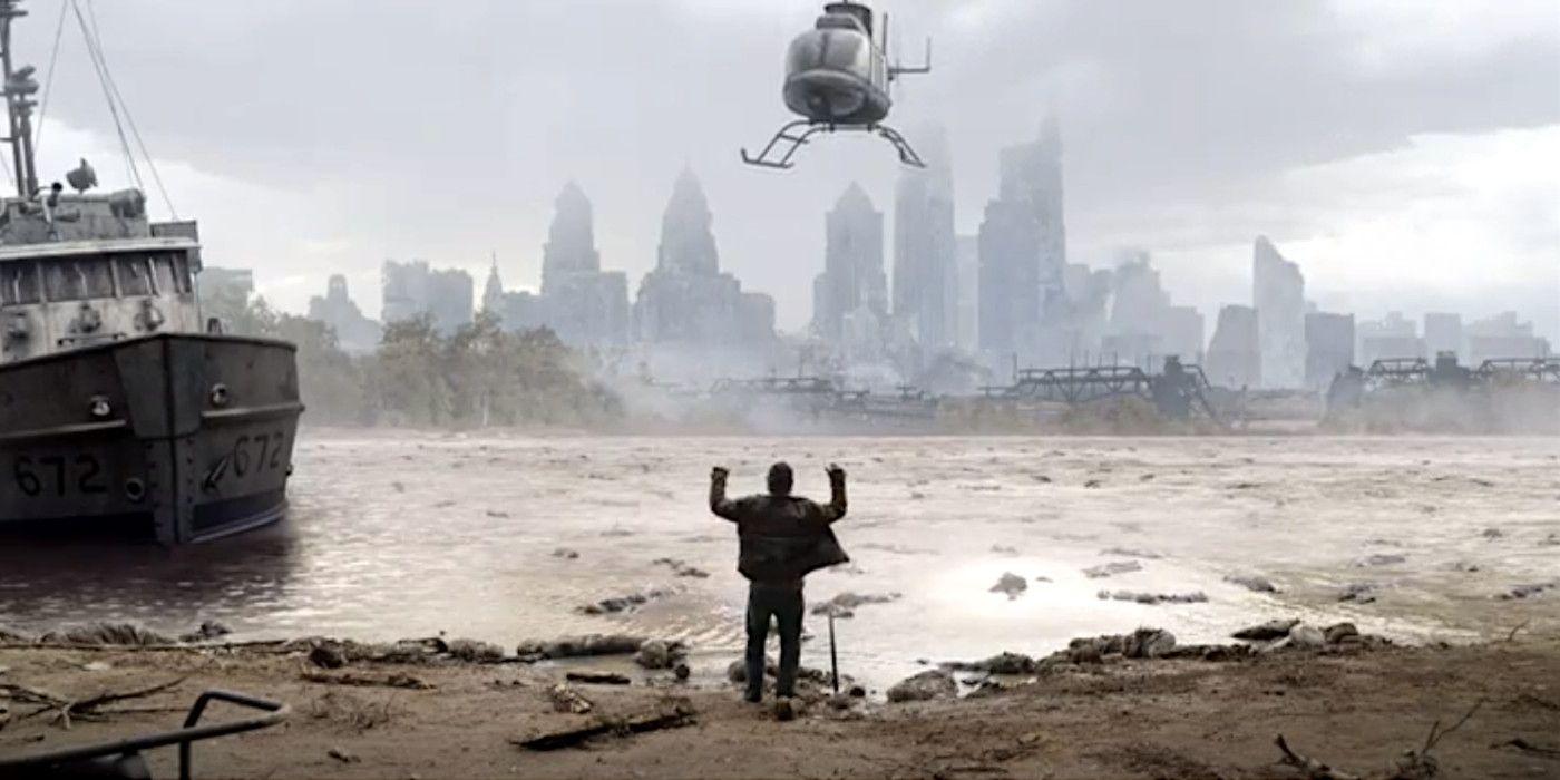 A silhouetted man stands on a muddy riverbank holding his hands up while a helicopter hovers menacingly above him, a hazy city skyline in the distance