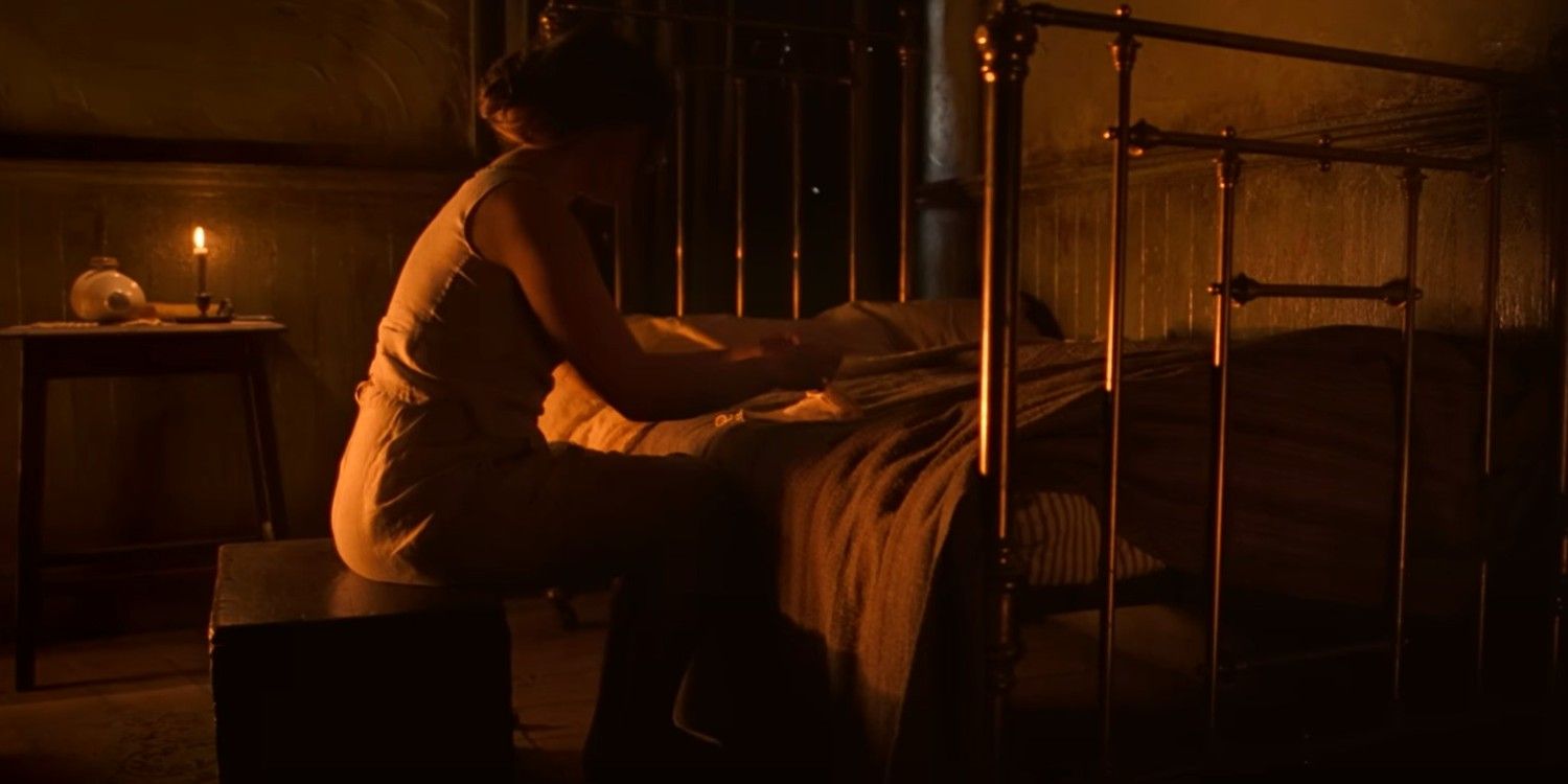 Lib kneeling at her bed in The Wonder