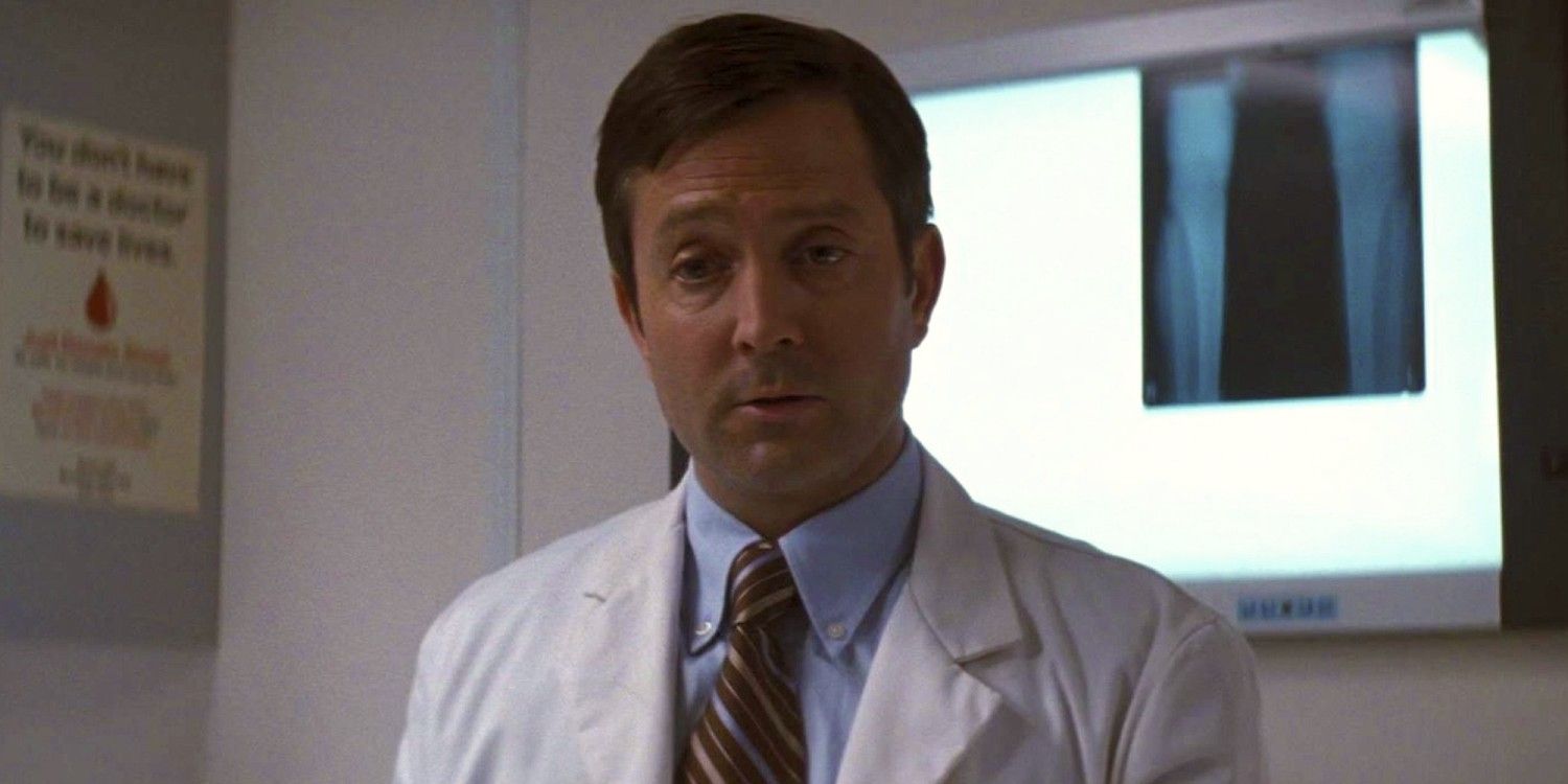 Thomas Lennon as a doctor mid-speech in The Dark Knight Rises