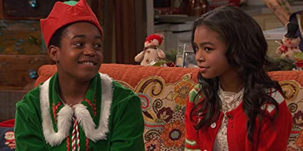 Booker and Nia sitting on the couch in Christmas clothes in Raven's Home