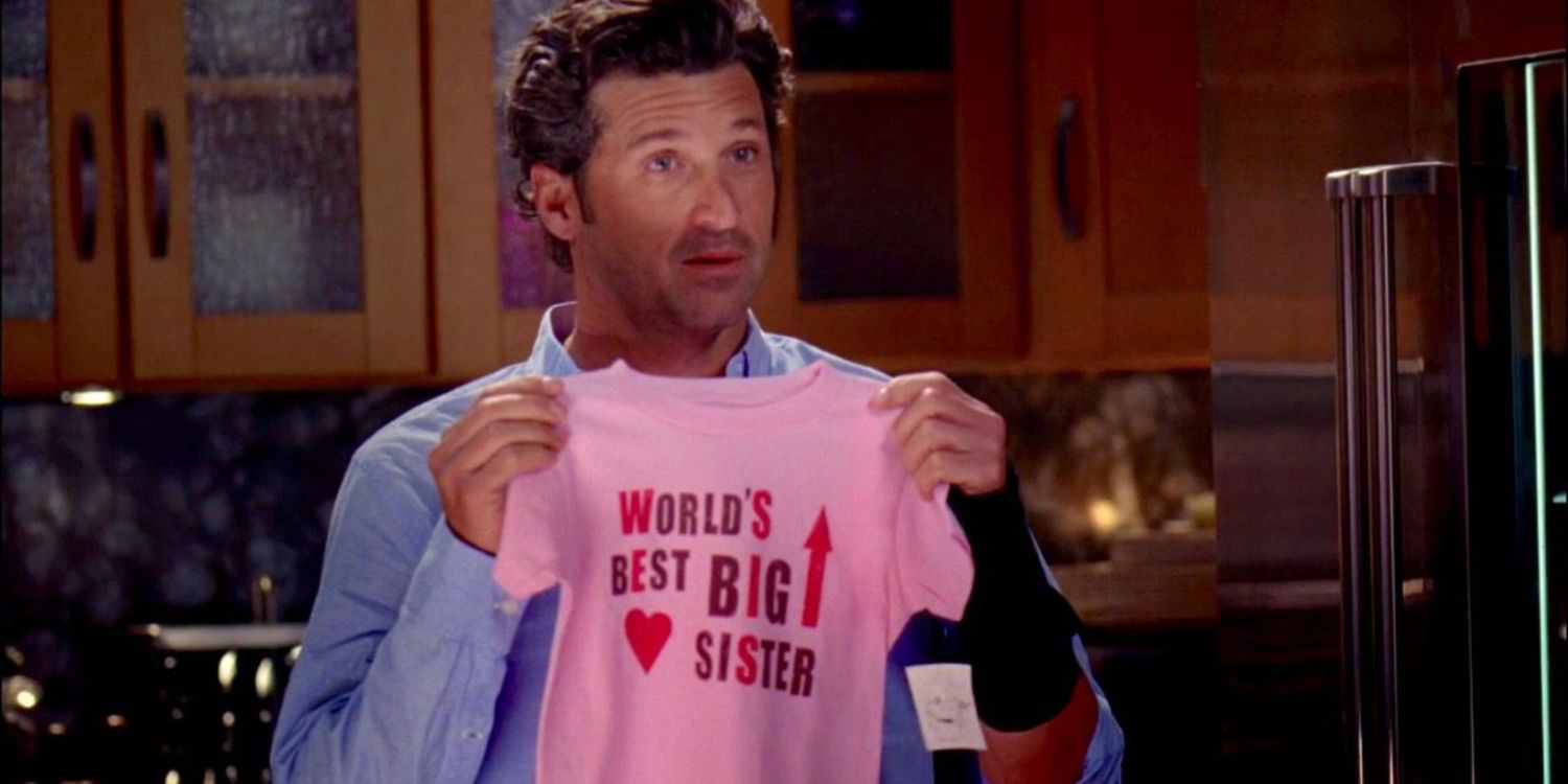 An image of Derek holding a child's T-Shirt in Grey's Anatomy