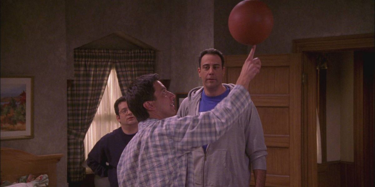 andy kindler and robert barone watching ray spin a basketball in everybody loves raymond