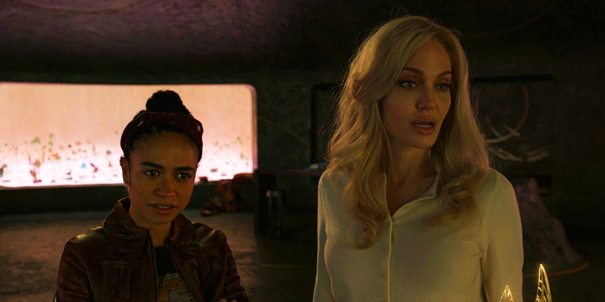 Angelina Jolie as Thena and Lauren Ridloff as Makkari looking surprised in Eternals